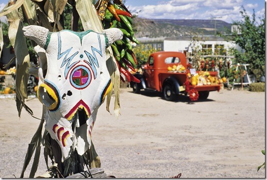A painted skull and a red pickup truck make a colorful fall scene at a fruit stand  near the  village of Velarde in  northern New Mexico.i