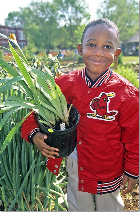 A young man clutches his newly purchased at the annual plant sale held by the Missouri Botanic Garden in St. Louis.